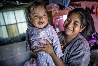 LAC mother holding up a baby