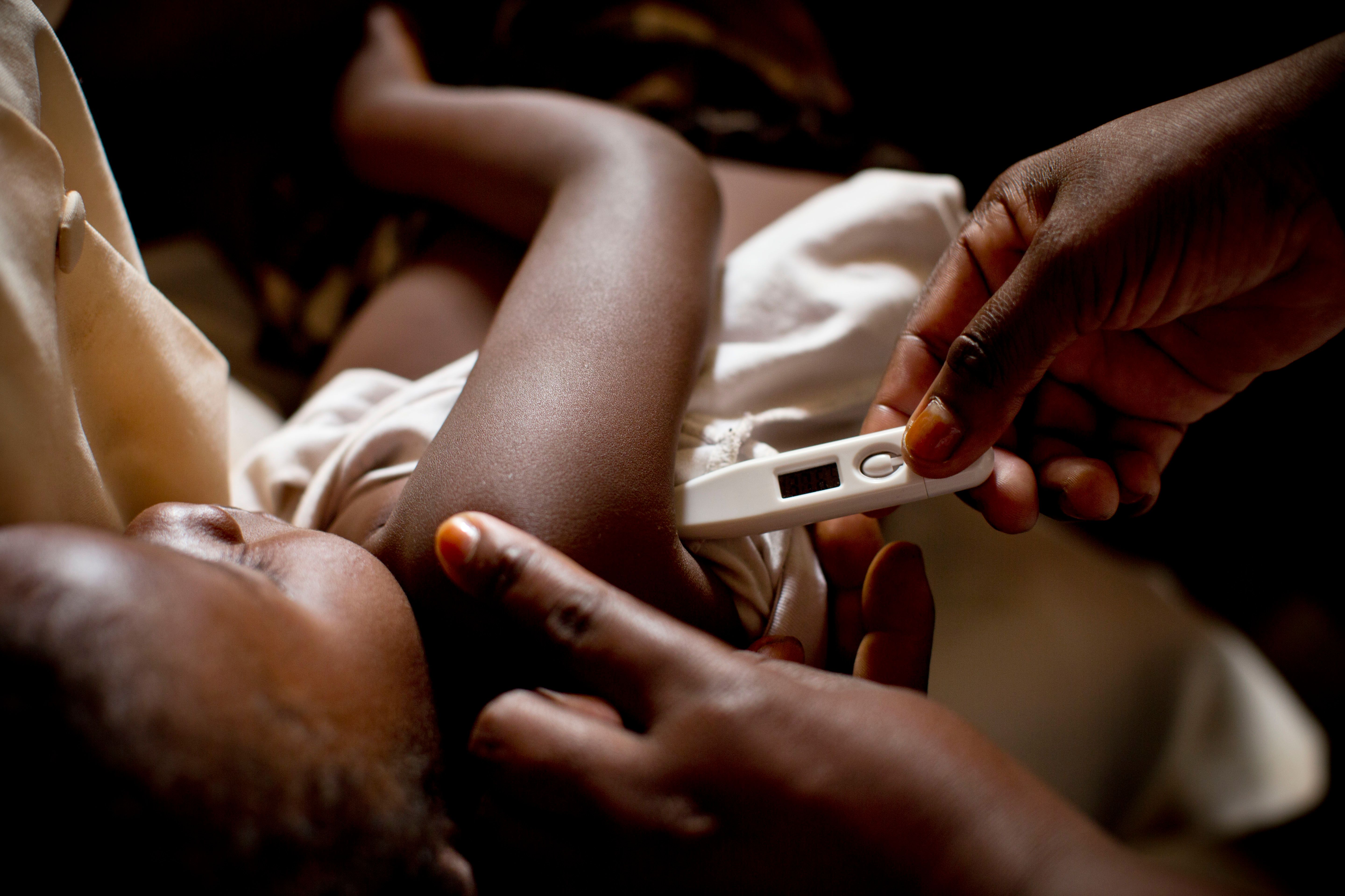 Child getting their temperature taken.