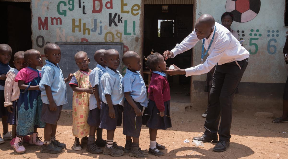 Kenyan children lined up for temperature check