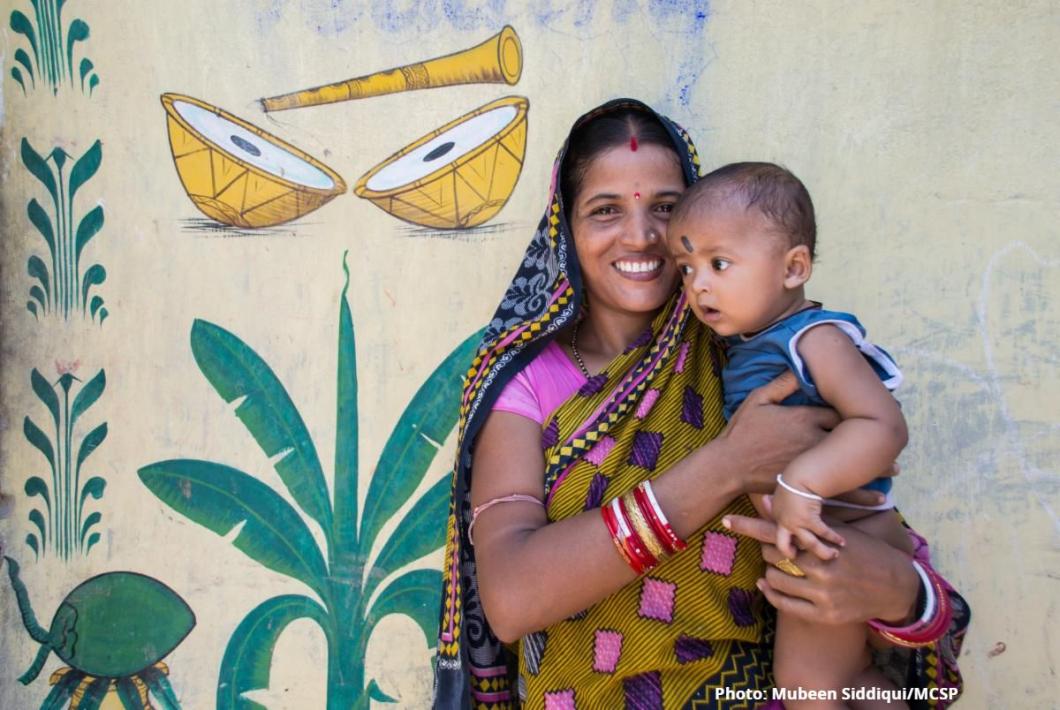 Woman holding a baby.