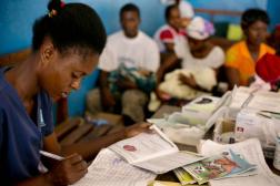 Photo of a woman looking over paperwork.