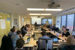 Photo of a large group of people at a table: Steering Committee Members, Subgroup Chairs, and Secretariat. Photo credit: Ashley Schmidt/MCSP