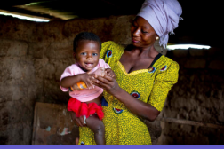 Report cover page, photo of woman holding baby, purple block of English text underneath