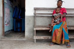 First page of DRC Country Case Study. Photo of woman with young child in lap.