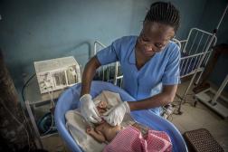 Healthcare worker provides oxygen to newborn