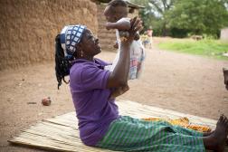 Woman holding up baby in the air