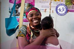 woman smiling and holding child