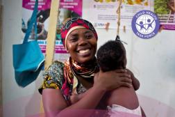 woman holding child smiling