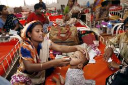 Woman giving medicine to child